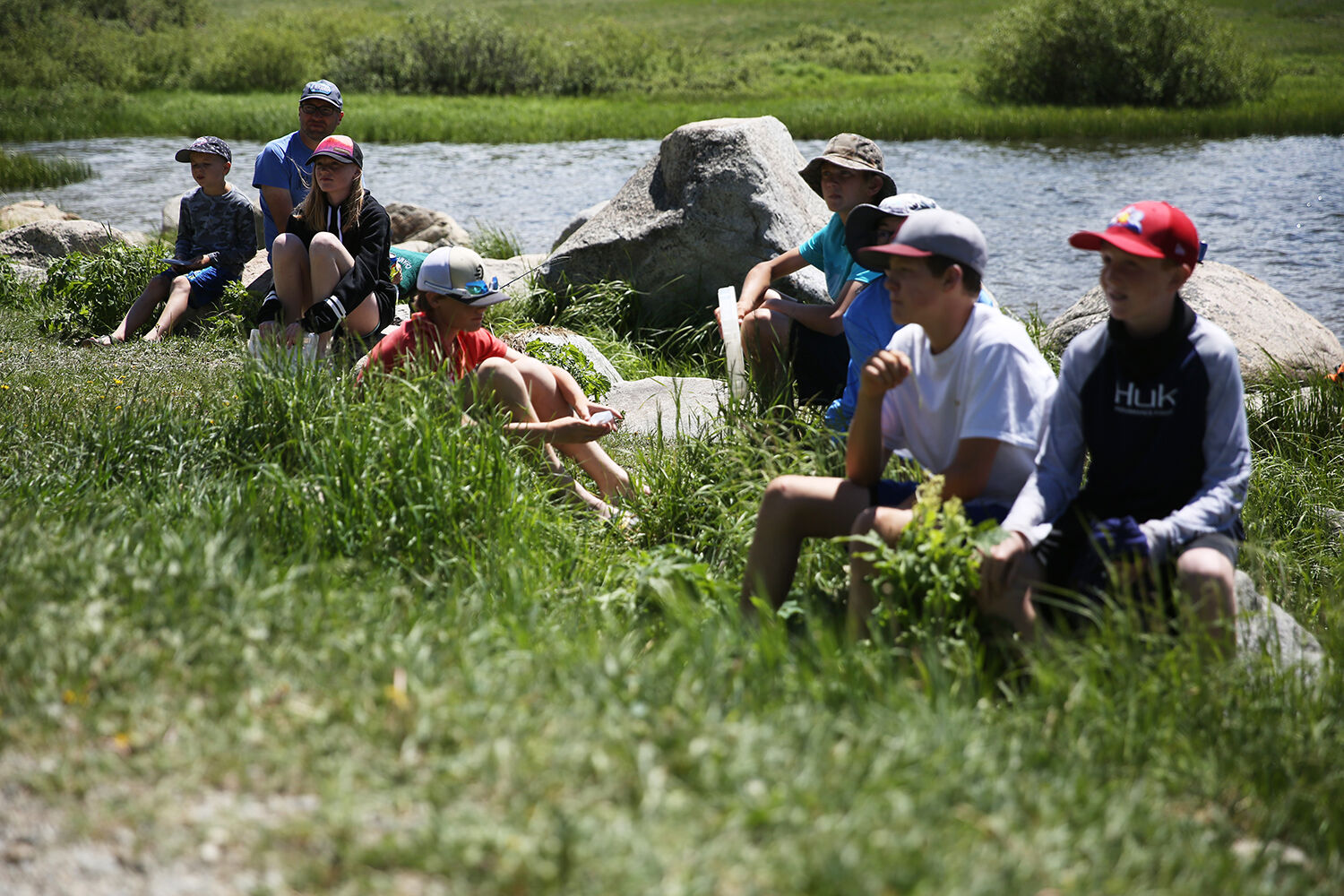 Participants and parents gathered around on the rocks